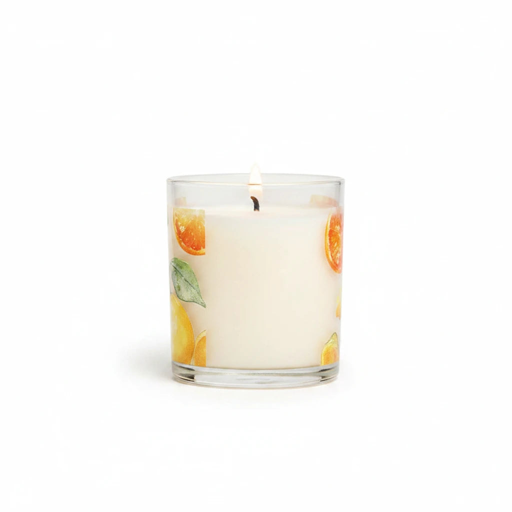 Mellow Monkey Fresh Citrus scented candle in a glass jar with orange and lemon slice illustrations