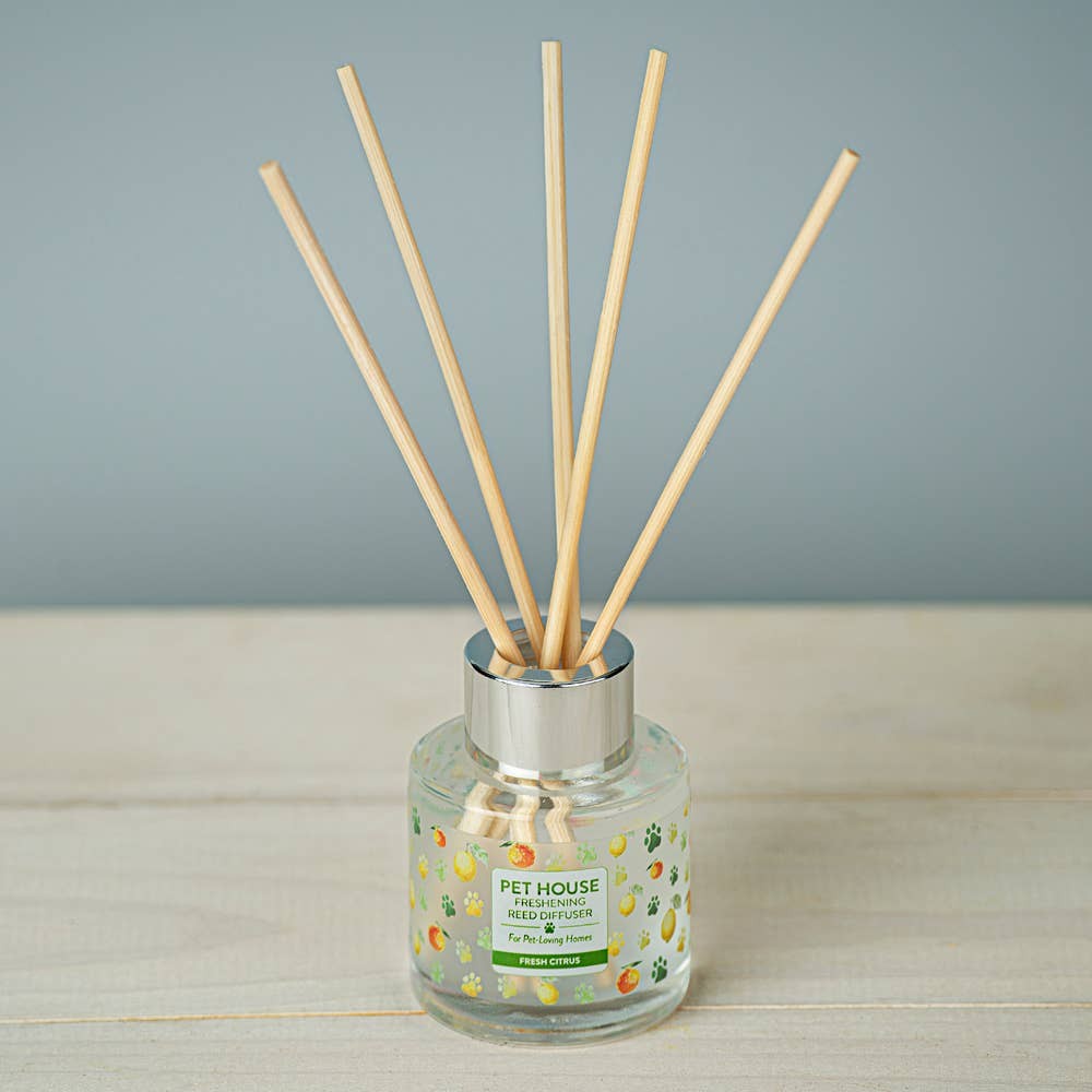 Mellow Monkey Pet House Fresh Citrus reed diffuser in a glass bottle with wooden reeds for neutralizing pet odors