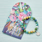 Mellow Monkey Friend bracelet with colorful polymer clay beads, silver spacers, and a prayer box charm on a display card