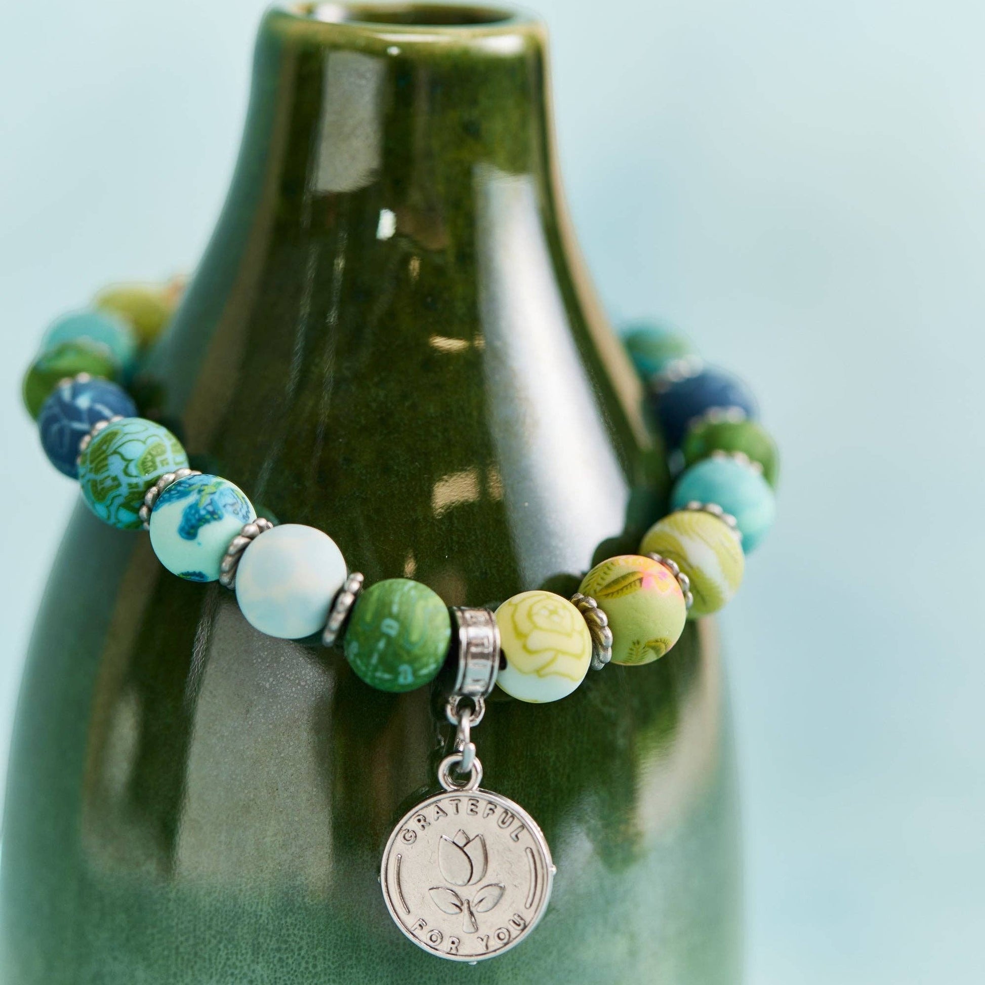Mellow Monkey Friend bracelet with multi-colored polymer clay beads, silver spacers, and a Grateful For You charm.
