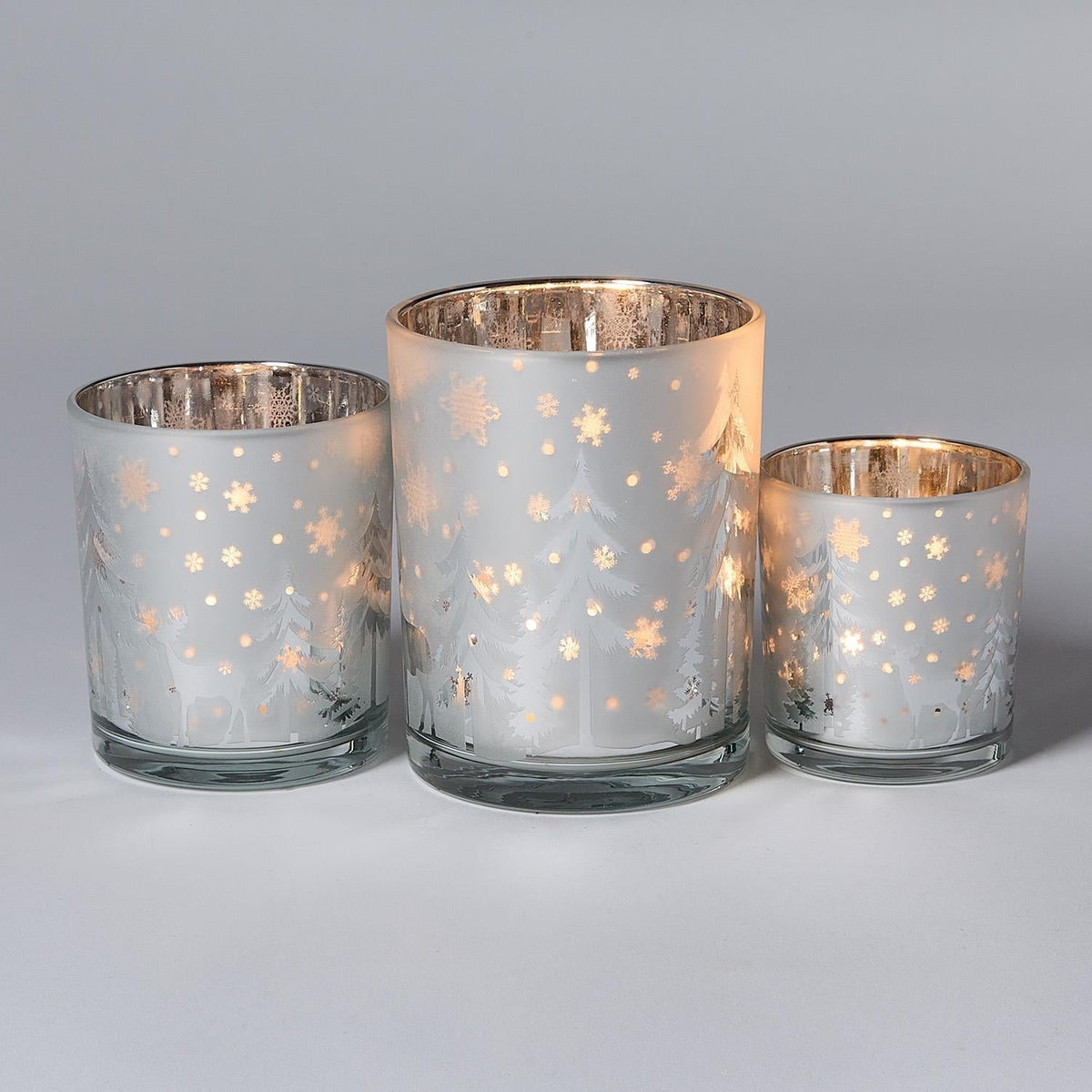 Mellow Monkey set of three frosted glass tealight candleholders with winter woodland deer and tree silhouettes