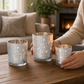 Mellow Monkey set of 3 frosted glass tealight holders with winter woodland deer and tree silhouettes on a wood table