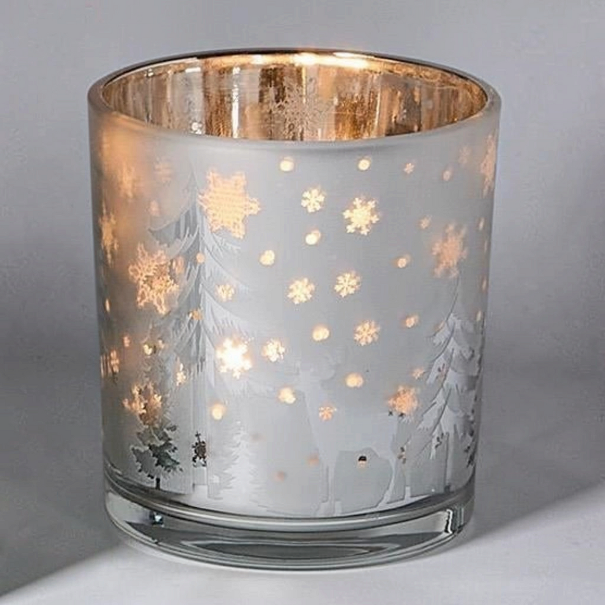 Mellow Monkey frosted glass tealight holder with a winter woodland scene featuring deer, trees, and snowflakes.