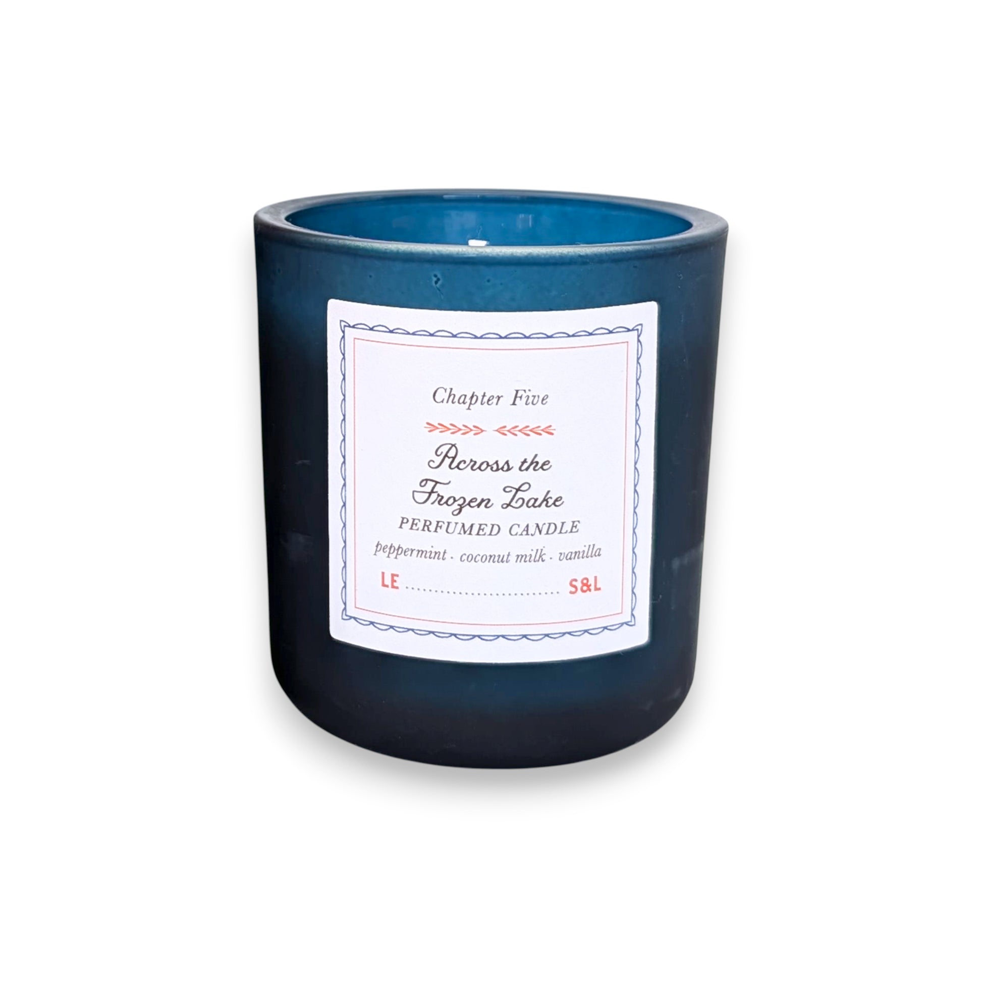 Mellow Monkey Across the Frozen Lake scented candle in a deep midnight blue glass vessel with a storybook label.