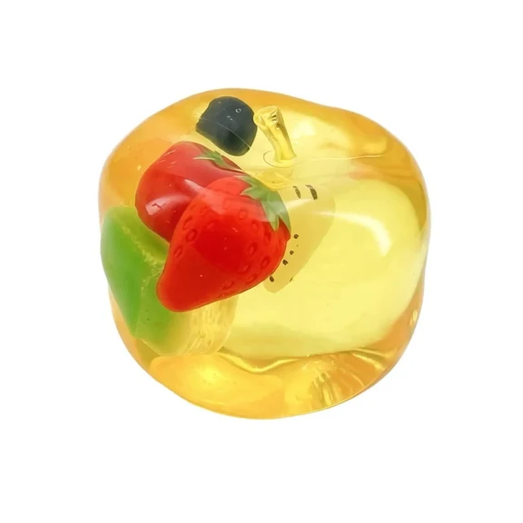 Mellow Monkey transparent yellow apple squishy filled with colorful strawberry and kiwi fruit pieces