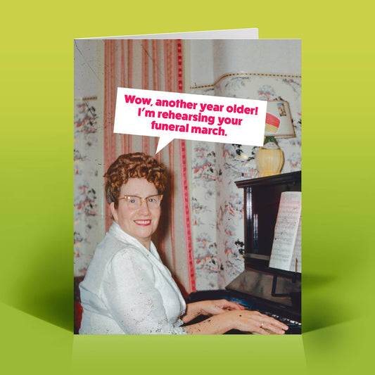 Mellow Monkey Funeral March birthday card featuring a vintage photo of a woman playing piano with a humorous quote.