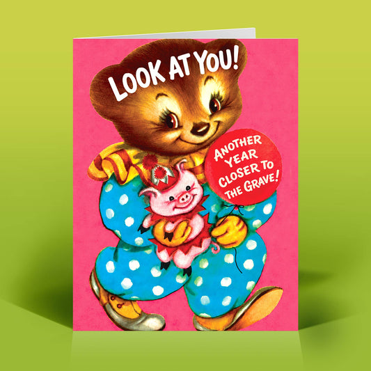Mellow Monkey funny birthday card featuring a vintage-style bear holding a piglet on a bright pink background.