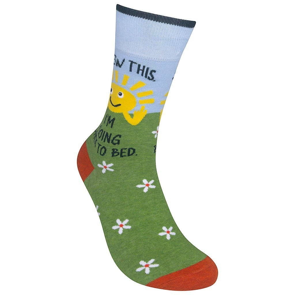 Mellow Monkey green crew socks featuring a smiling sun, white daisies, and the text Screw This I'm Going Back To Bed