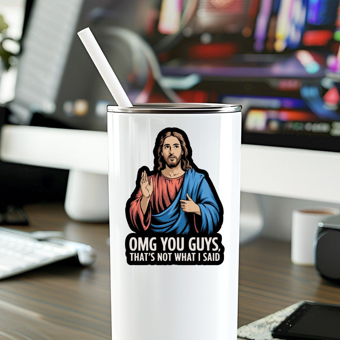 Mellow Monkey waterproof vinyl sticker featuring a humorous Jesus illustration on a white tumbler on a desk.
