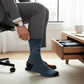 Mellow Monkey navy and light blue striped crew socks with I Love Meetings About Meetings text worn by a professional