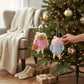 Mellow Monkey fur coat mice ornaments in pink and blue hanging on a decorated Christmas tree