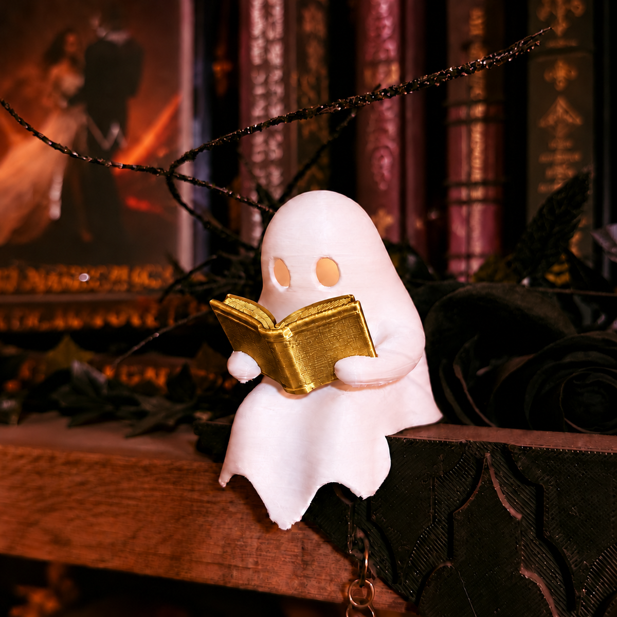 Mellow Monkey white ghost figurine reading a gold book with an LED tealight glow, perched on a dark bookshelf.