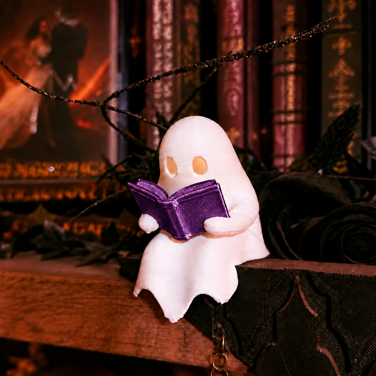 Mellow Monkey white ghost figurine reading a purple book with an LED tealight glow on a bookshelf