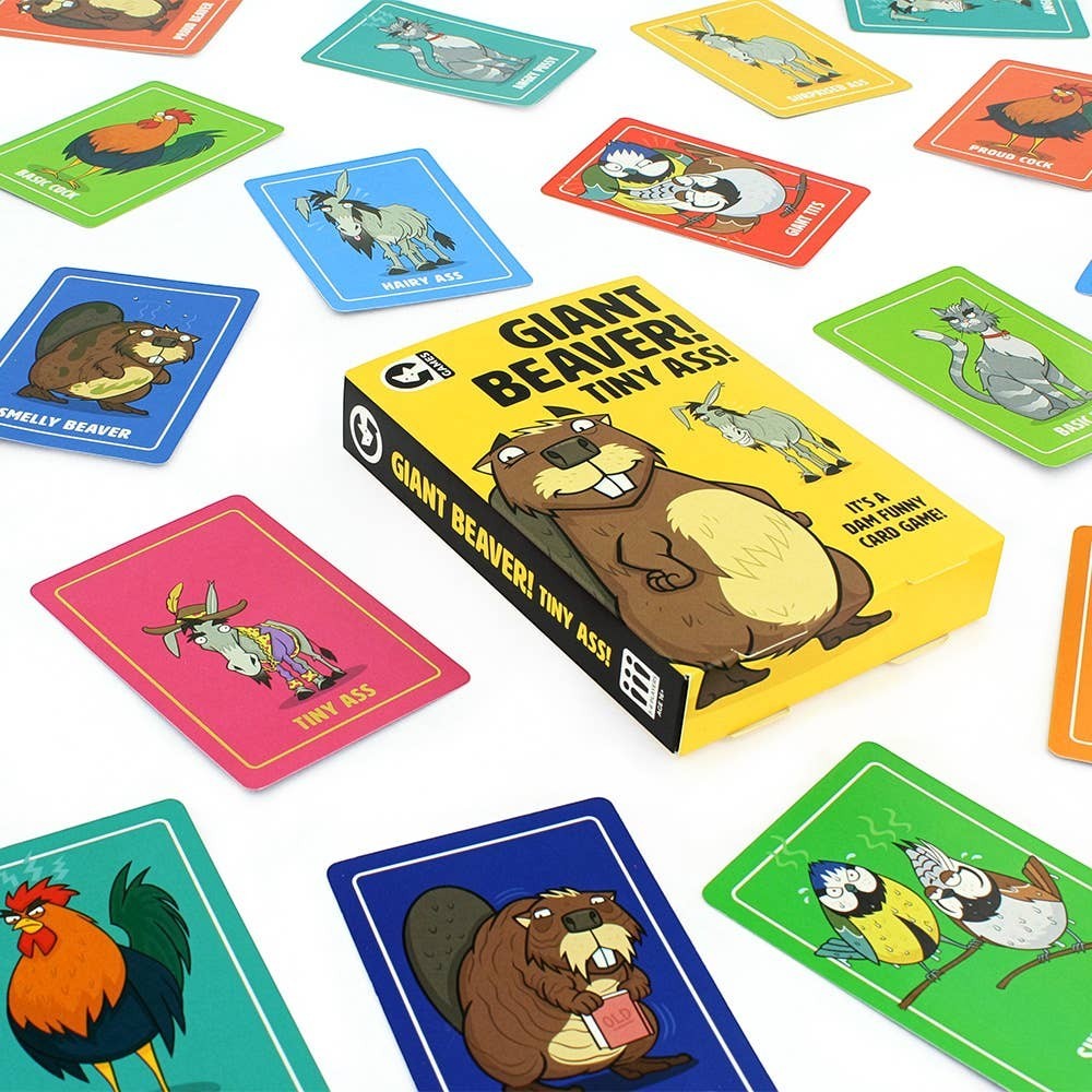Mellow Monkey Giant Beaver! Tiny Ass! card game box with colourful illustrated animal cards spread on a white surface