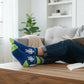 Mellow Monkey blue crew socks with Gifted text and stick figure design worn by a person reading on a couch