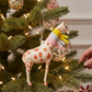 Mellow Monkey glass giraffe ornament with a multi-colored felt scarf hanging on a decorated Christmas tree