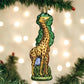 Mellow Monkey Old World Christmas blown glass giraffe ornament with green tree detail. 5.5-inch.