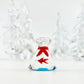 Mellow Monkey 1-inch miniature glass bag containing a tiny red glass fish with a red ribbon detail