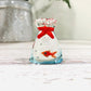Mellow Monkey 1-inch miniature glass goldfish figurine inside a clear glass bag with a red tie detail