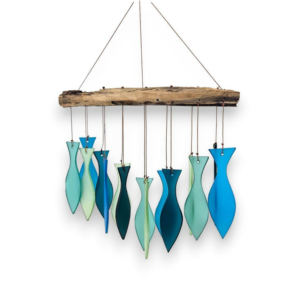 Mellow Monkey handcrafted wind chime featuring blue and green sandblasted glass fish hanging from a driftwood branch.