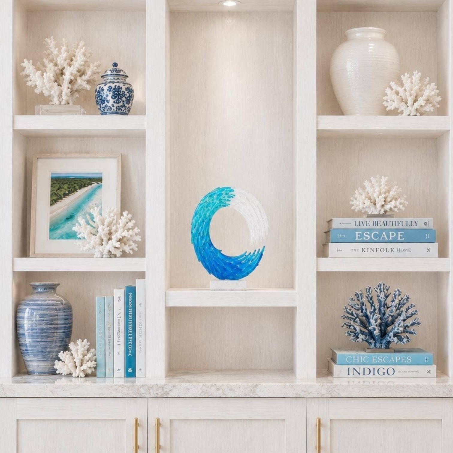 Mellow Monkey handmade 13-inch blue and white fused glass ocean wave sculpture displayed on a white bookshelf.