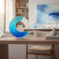 Mellow Monkey 13-inch handmade glass ocean wave sculpture with blue and white translucent layers on a wooden table.