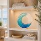 Mellow Monkey 13-inch handmade fused glass ocean wave sculpture with blue and white tones on a white bookshelf.