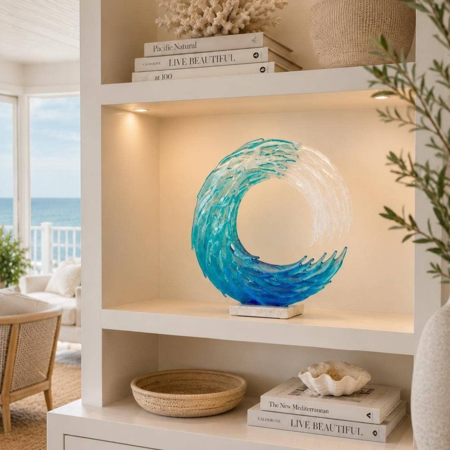 Mellow Monkey 13-inch handmade fused glass ocean wave sculpture with blue and white tones on a white bookshelf.