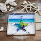 Mellow Monkey 7-inch hand-blown glass starfish ornament with vibrant blue, green, and purple hues in a gift box.