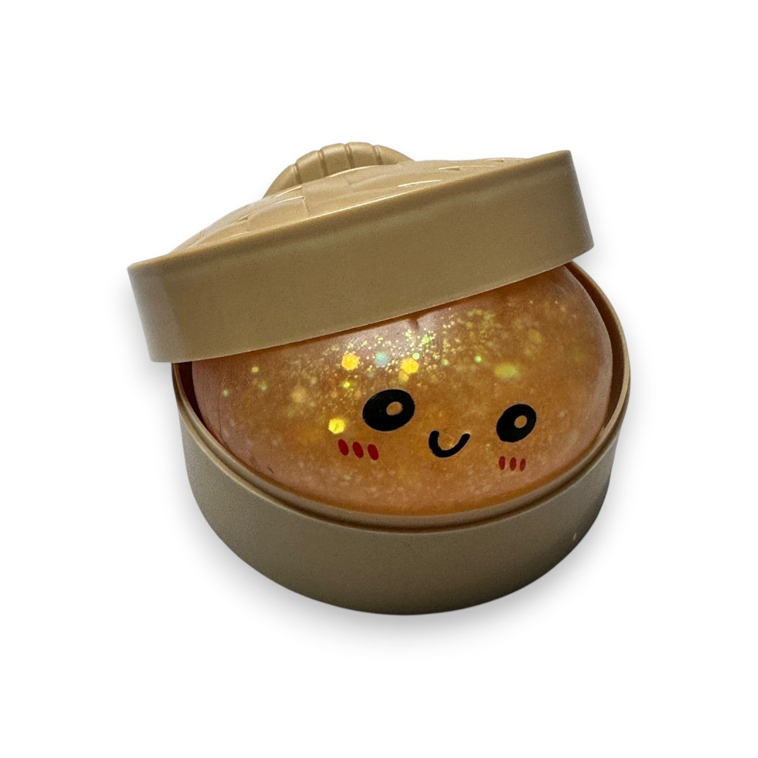 Mellow Monkey rainbow glitter mystery dumpling squeeze toy with a cute face inside a plastic steamer basket container.