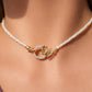 Mellow Monkey 18K gold plated choker with mother of pearl beads and a butterfly clasp with cubic zirconia.
