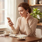 Woman wearing Mellow Monkey gold jellyfish earrings with AB aqua accents while looking at her smartphone.