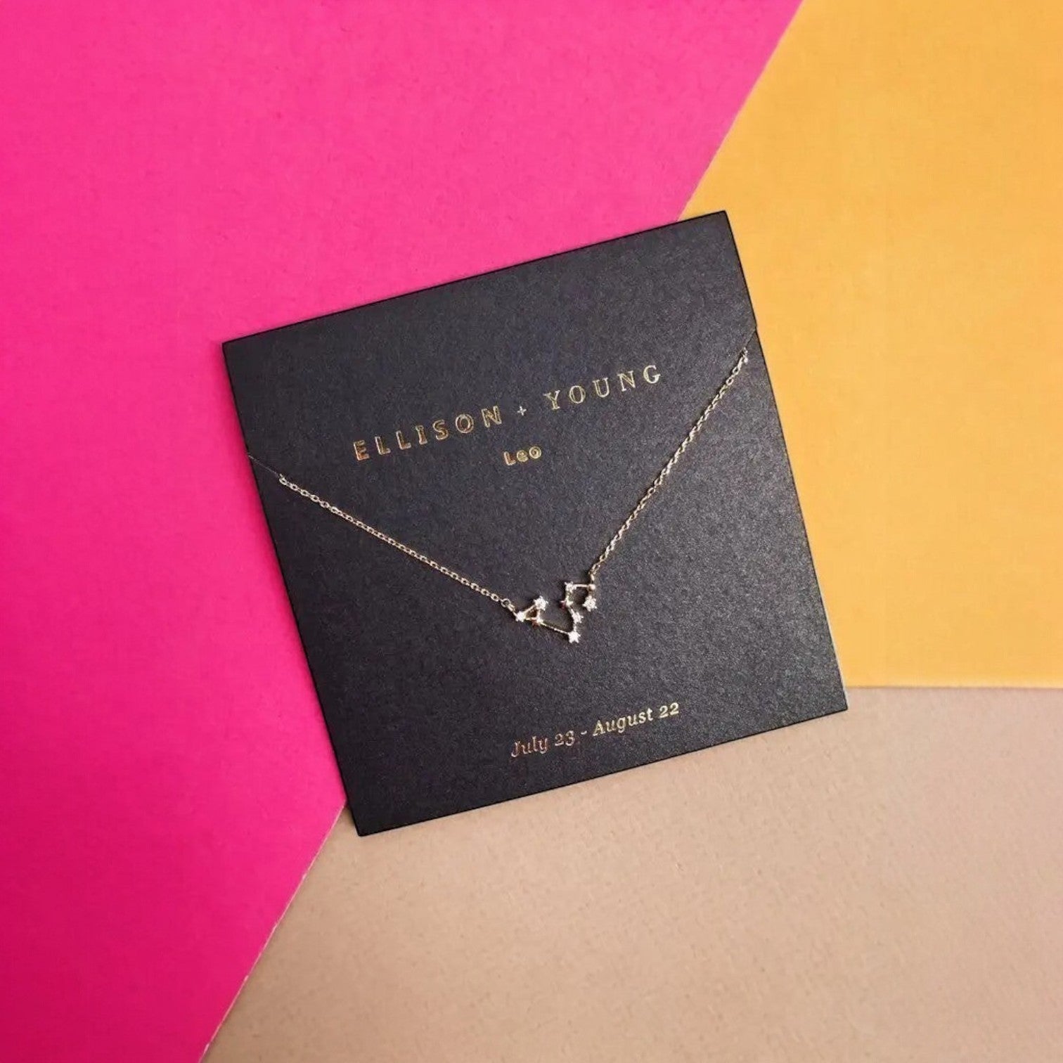 Mellow Monkey gold Leo zodiac constellation necklace with cubic zirconia accents on a black card. 16-inch chain with extension.