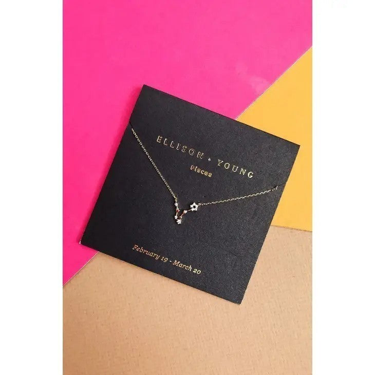 Mellow Monkey gold Pisces constellation necklace with cubic zirconia details on a black card, 16-inch length.