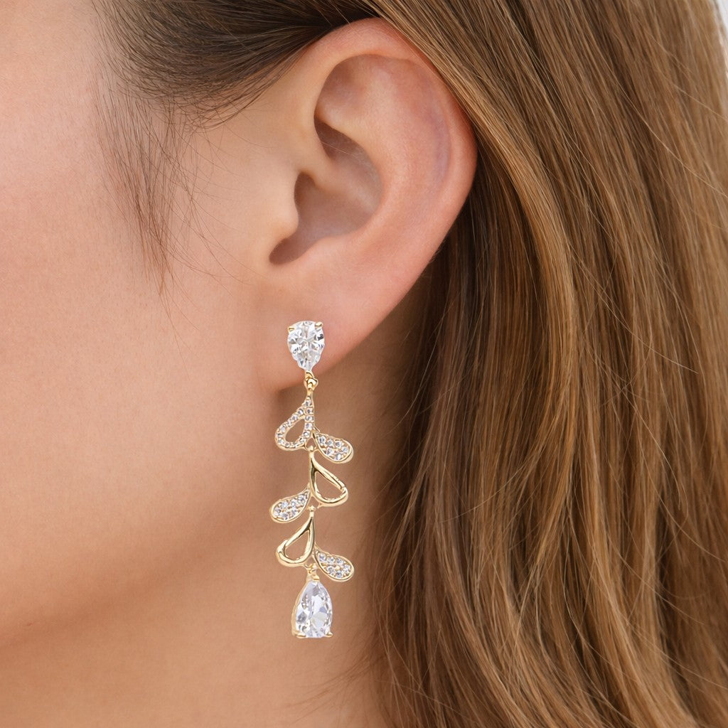 Mellow Monkey 18k gold plated dangle earrings with cubic zirconia in a vine design, featuring pear-shaped stones.