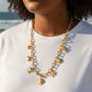 Mellow Monkey 18K gold dipped stainless steel chain necklace with sea life charms: starfish, heart, dolphin, fish, and shells.
