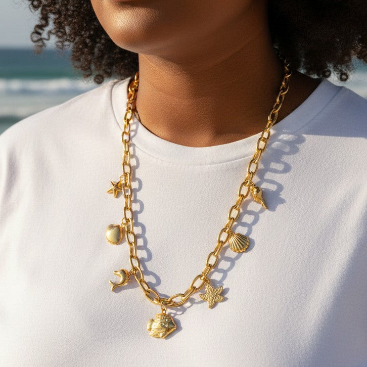Mellow Monkey 18K gold dipped stainless steel chain necklace with sea life charms: starfish, heart, dolphin, fish, and shells.