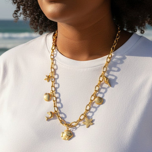 Mellow Monkey 18K gold dipped stainless steel chain necklace with sea life charms: starfish, heart, dolphin, fish, and shells.