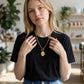 Mellow Monkey 18k gold plated oval starburst necklace with cubic zirconia on an 18-inch chain worn by a woman.