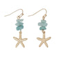 Mellow Monkey gold starfish drop earrings with light blue semiprecious stone beads for a coastal beach look.