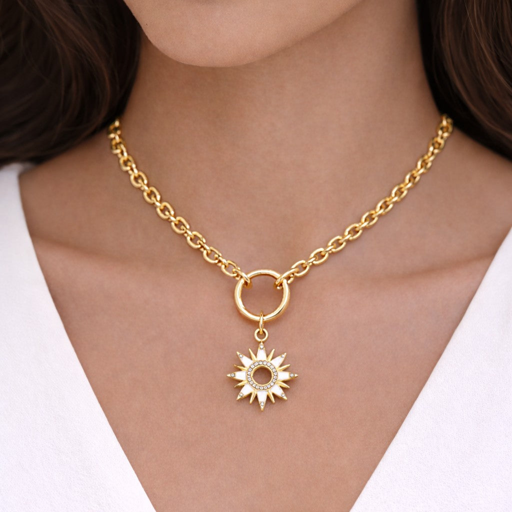 Mellow Monkey gold plated sun pendant necklace with white enamel and cubic zirconia details on a 16-inch chain.