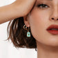 Mellow Monkey 18k gold plated hoop earrings with a rectangular teal enamel pendant and cubic zirconia accents.