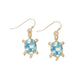 Mellow Monkey gold-tone turtle earrings featuring blue marble enamel shells on hook backings for coastal style.