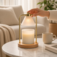 Mellow Monkey Golden Glow candle warmer lamp with brushed gold arch, frosted shade, and wood base on marble table