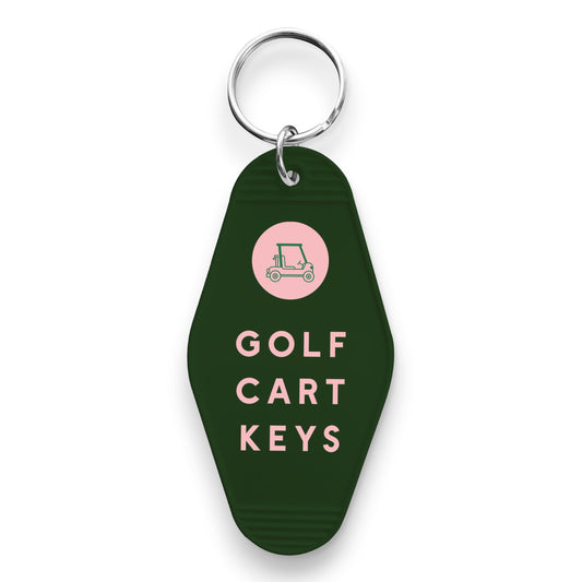 Mellow Monkey dark green motel-style keychain with a pink golf cart icon and Golf Cart Keys text in pink lettering.
