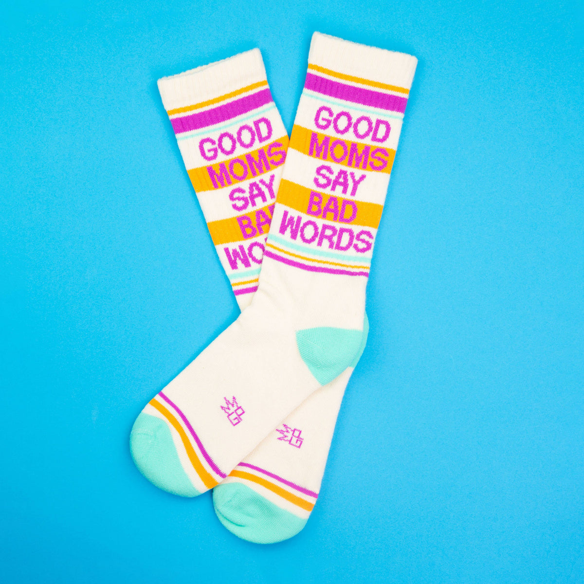 Mellow Monkey crew socks in cream with pink, orange, and teal stripes featuring the text Good Moms Say Bad Words