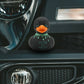 Mellow Monkey gothic rubber duck with neon green blood drips and Cute But Dead Inside text on a car dashboard