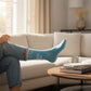 Mellow Monkey heathered blue crew socks with white text reading I'm Silently Correcting Your Grammar on a person
