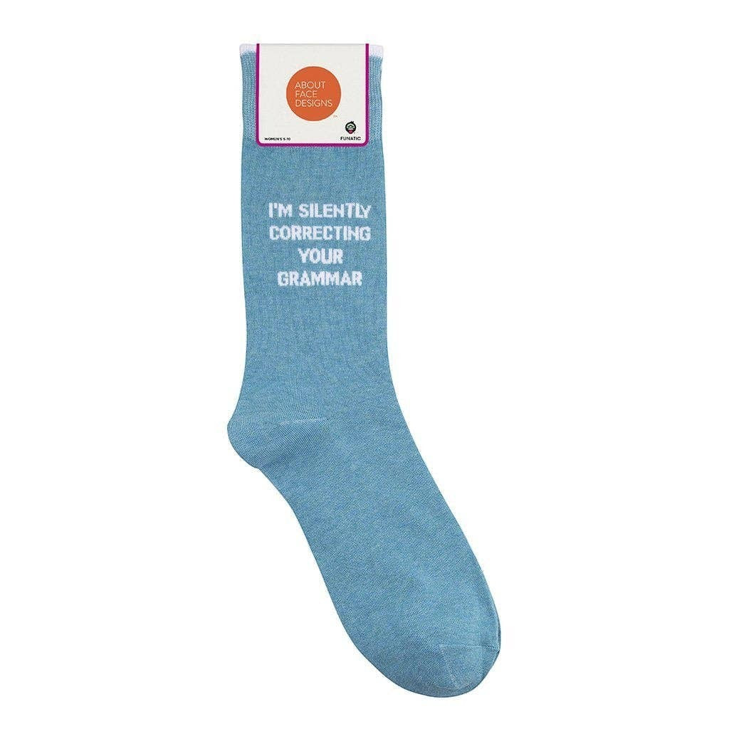 Mellow Monkey light blue novelty socks featuring the text I'm Silently Correcting Your Grammar in white block letters.