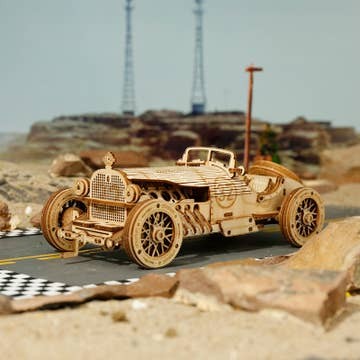 Mellow Monkey 3D laser cut wooden puzzle of a vintage Grand Prix race car, 220 pieces, natural wood finish.